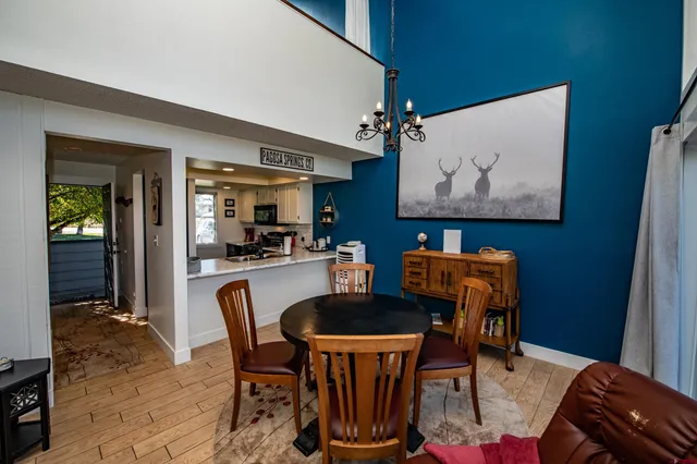 a dining room with furniture and wooden floor