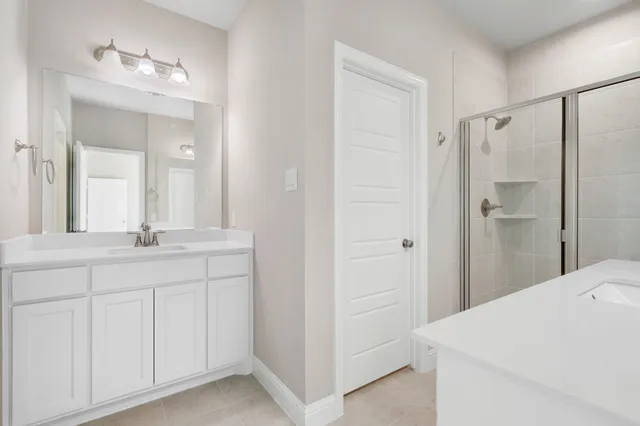 a bathroom with a double vanity sink and mirror