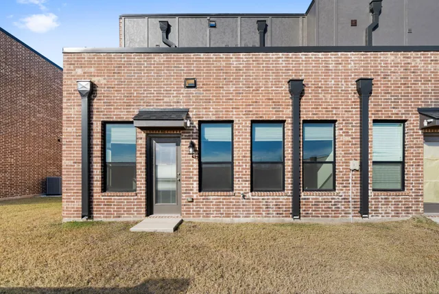 a view of a brick house with windows