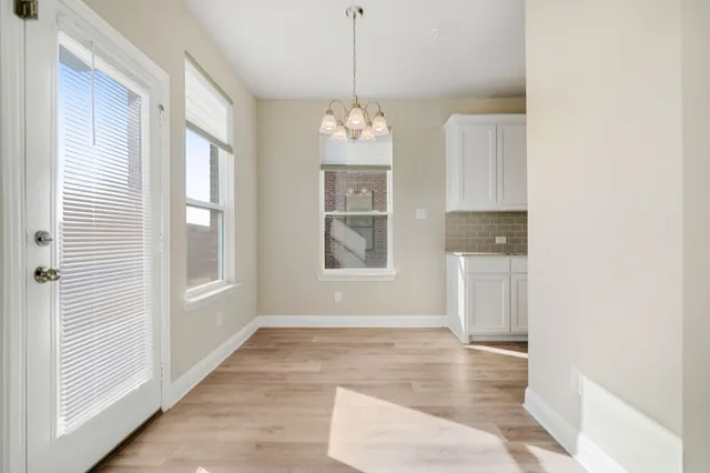 a view of an room with wooden floor and windows
