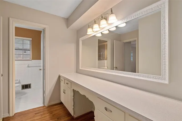a bathroom with a sink a toilet and mirror