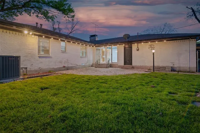 a view of a house with a big yard and garage