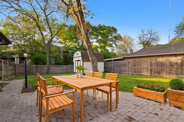 a view of a backyard with sitting area