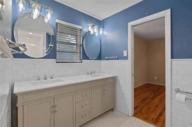 a bathroom with a double vanity sink and a mirror