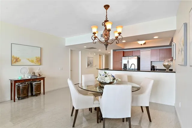 a view of a dining room with furniture and chandelier