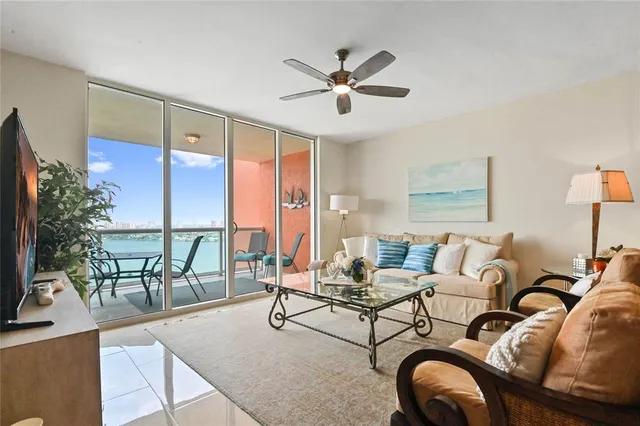 a living room with furniture and a floor to ceiling window