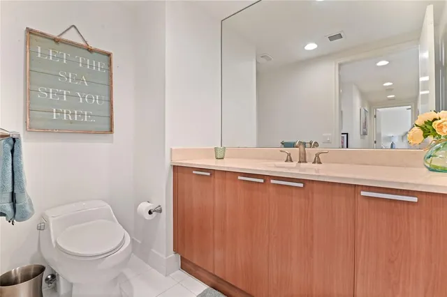 a bathroom with a sink toilet and mirror