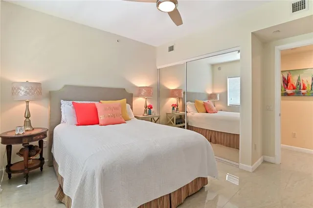 a bedroom with bed and a chandelier