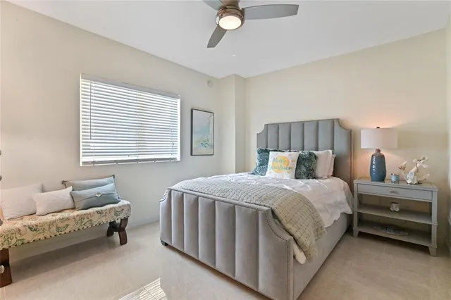 a bedroom with a bed a couch and a window