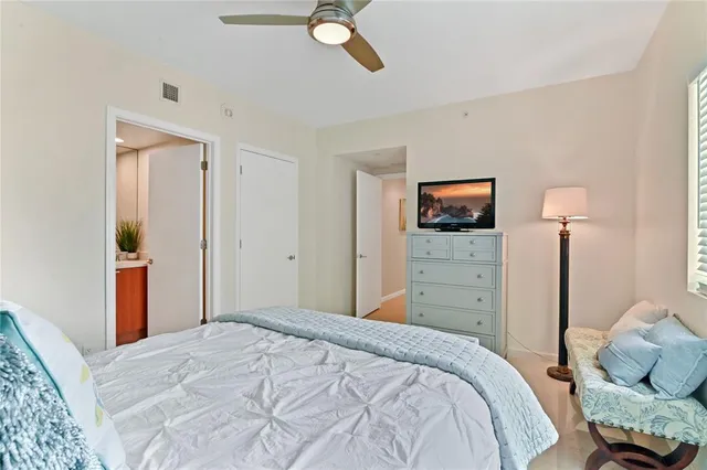 a bedroom with a bed and a television