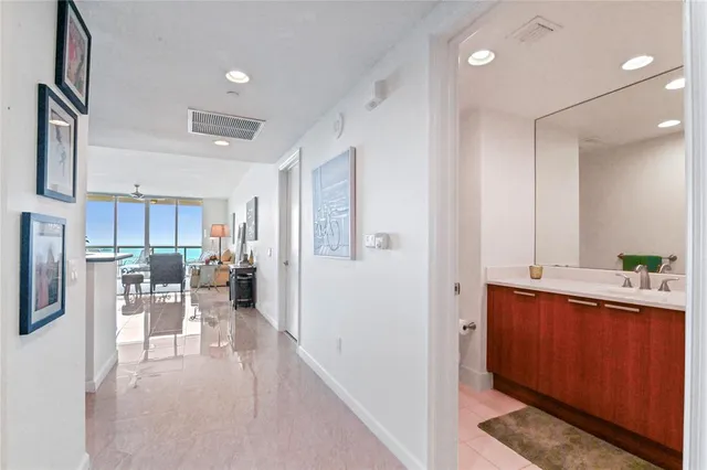a view of a kitchen with kitchen island white cabinets and wooden floor