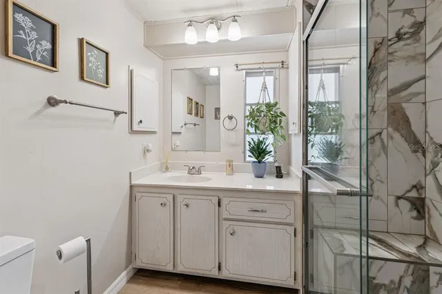 a bedroom with two beds and a desk