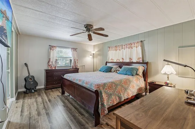 a bedroom with a bed a window and a chandelier