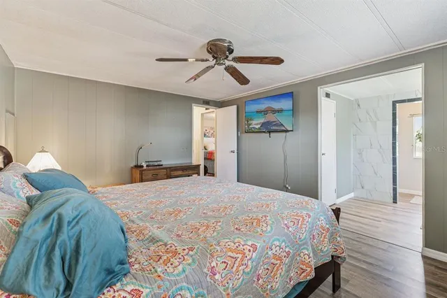 a bedroom with a bed and wooden floor