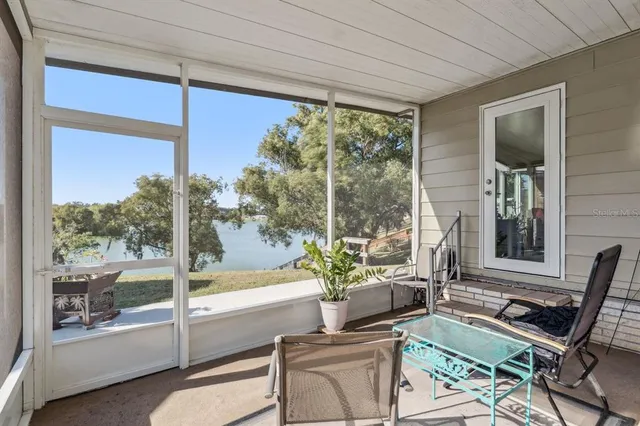 a view of a chair and table in backyard of the house