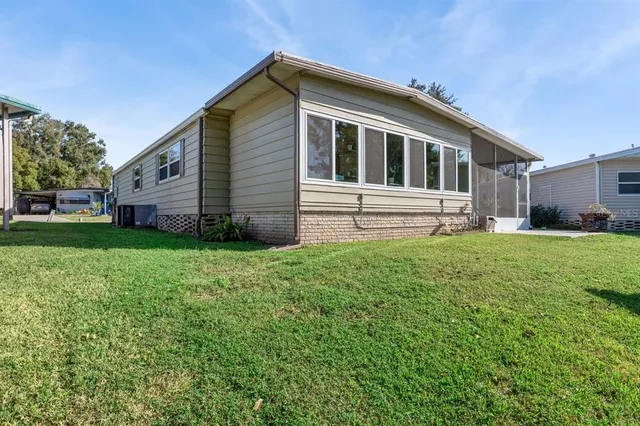 a front view of a house with a yard and trees