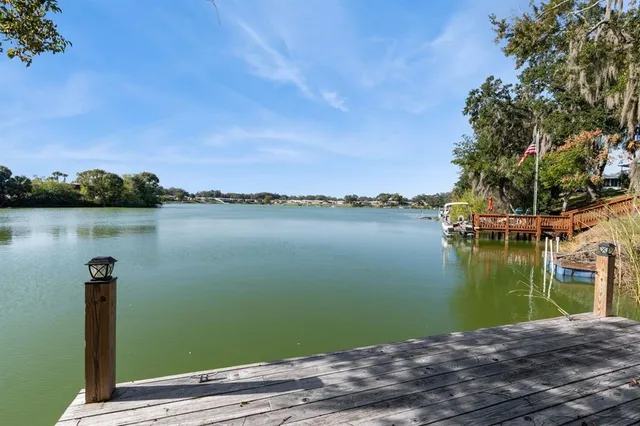 a view of a patio with table and chairs with wooden floor