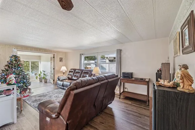 a living room with furniture fireplace and a potted plant