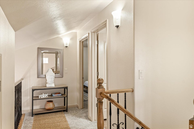345 North 2450th Street East, Unit 152 St. George, UT 84790 - Photo 25 of 40 Corridor featuring light colored carpet and an upstairs landing