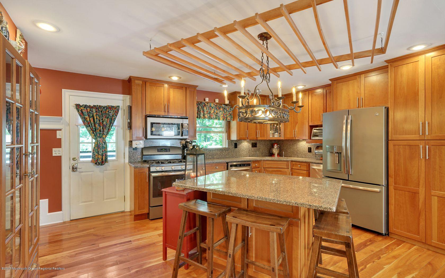 340 Jackson Pines Road Jackson, NJ 08527 - Photo 12 of 41 a kitchen with a refrigerator a microwave a stove and a sink with wooden floor