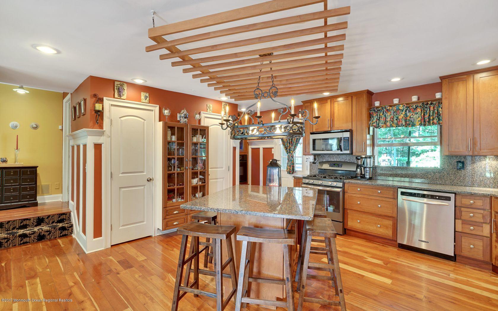 340 Jackson Pines Road Jackson, NJ 08527 - Photo 13 of 41 a kitchen with stainless steel appliances granite countertop a refrigerator a stove and a wooden floor