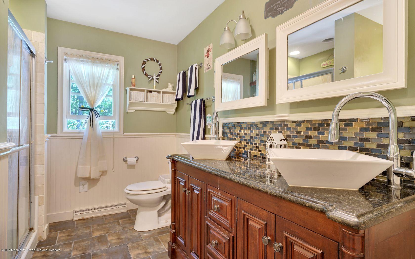 340 Jackson Pines Road Jackson, NJ 08527 - Photo 21 of 41 a bathroom with a granite countertop sink and a large mirror