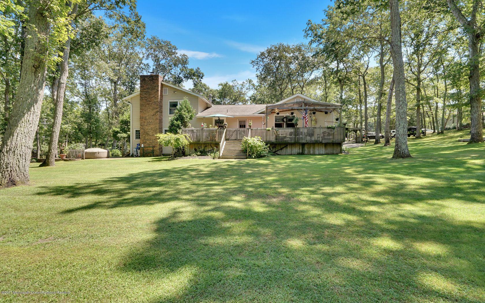 340 Jackson Pines Road Jackson, NJ 08527 - Photo 28 of 41 a view of a house with a big yard and large trees