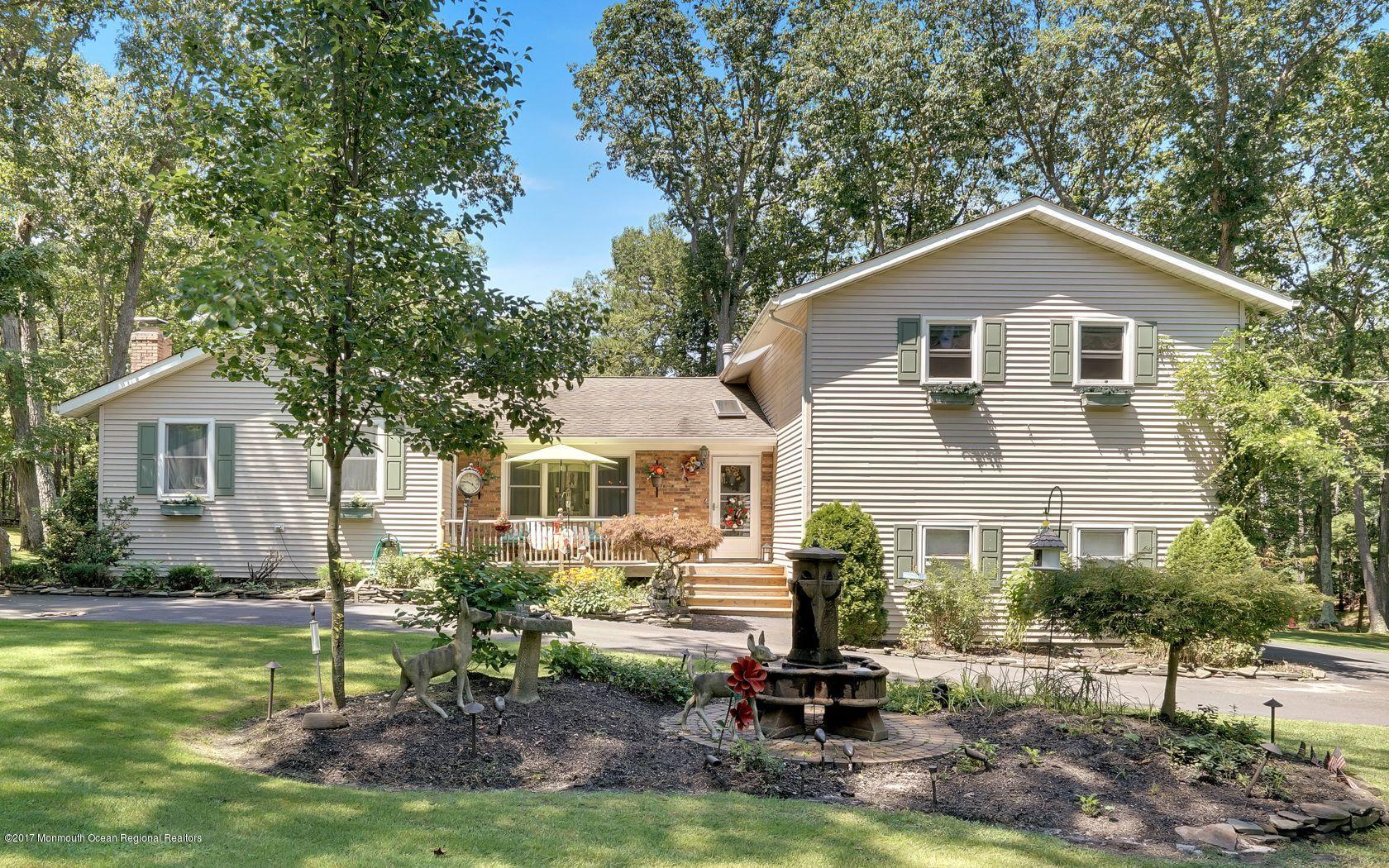 340 Jackson Pines Road Jackson, NJ 08527 - Photo 34 of 41 a view of a yard in front of a house with large windows
