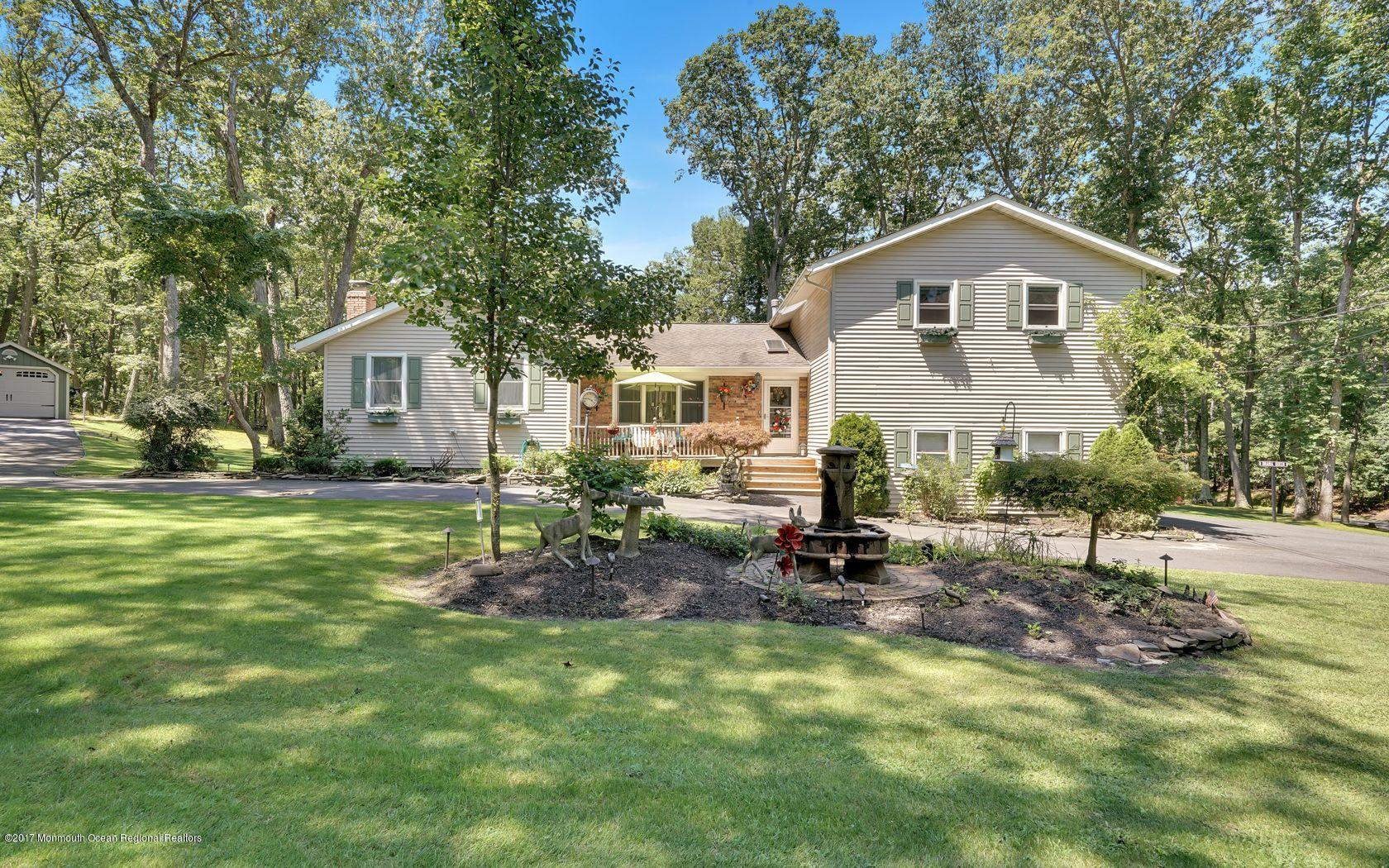 340 Jackson Pines Road Jackson, NJ 08527 - Photo 38 of 41 a front view of a house with a garden and trees
