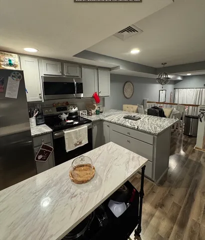 a kitchen with a sink a stove and chairs