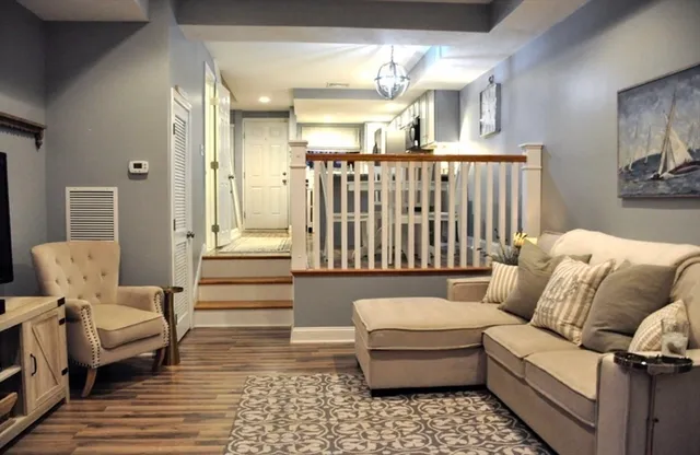 a living room with furniture and wooden floor
