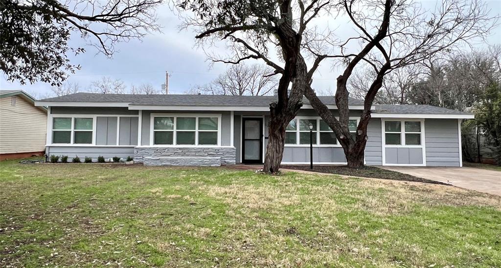 a house that has a tree in front of it