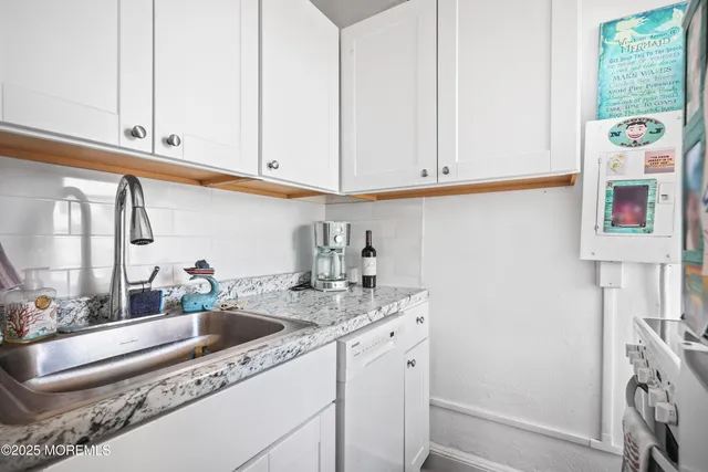 a view of a hallway with wooden floor and a livingroom view