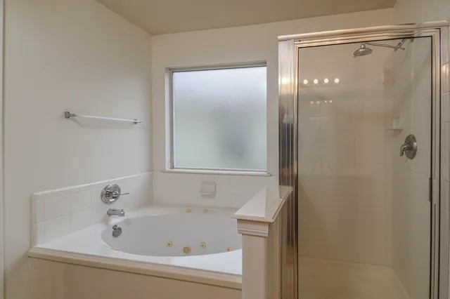 a bathroom with a bathtub and shower