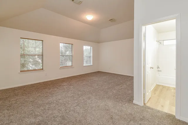 an empty room with windows and closet