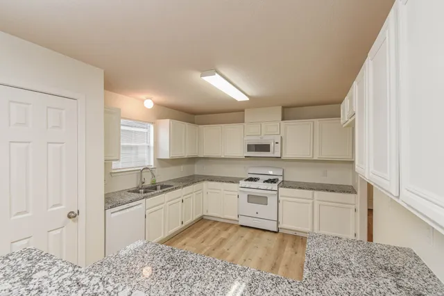 a kitchen with a sink and cabinets