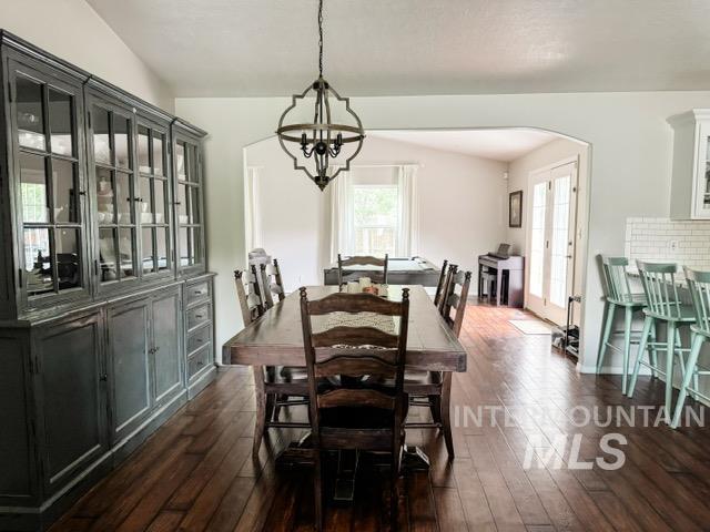 808 O'Leary Way Twin Falls, ID 83301 - Photo 10 of 37 Spacious dining area featuring wood-finish flooring, a vaulted ceiling, and an ornate chandelier