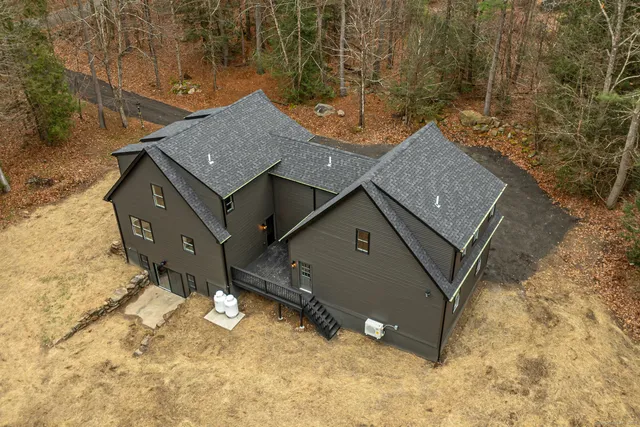 an aerial view of a house with a yard