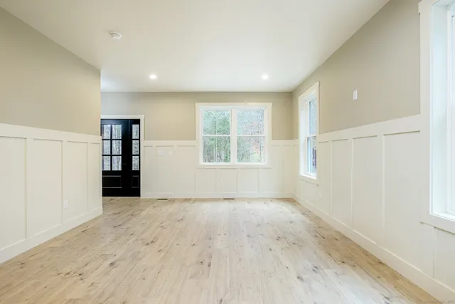 an empty room with windows and closet