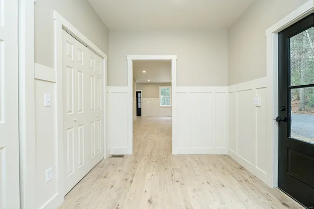 a view of hallway with wooden floor and windows