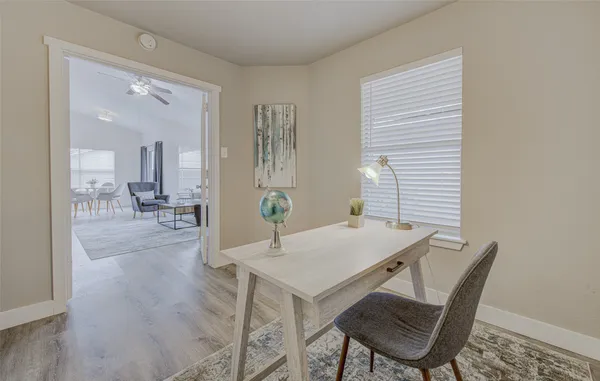 a view of a dining room with furniture and wooden floor