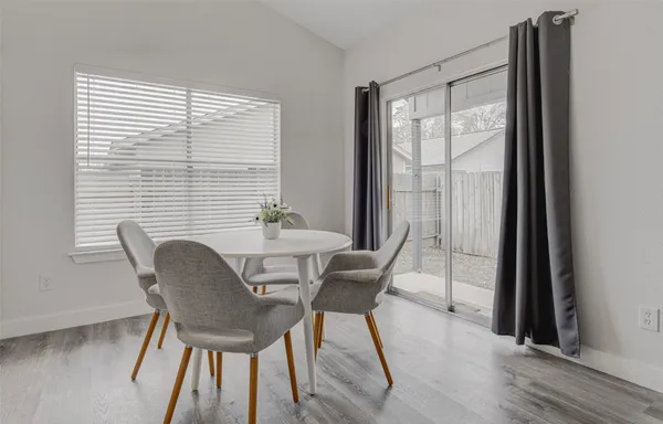 a view of a dining room with furniture and wooden floor