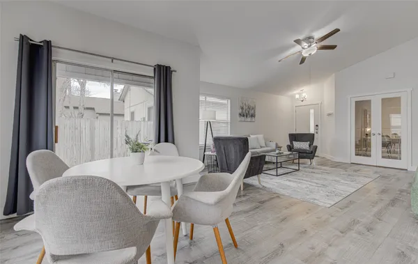 a view of a dining room with furniture and a large window
