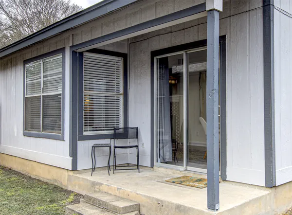 a wooden bench sitting in front of a building
