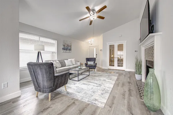 a living room with furniture and a wooden floor