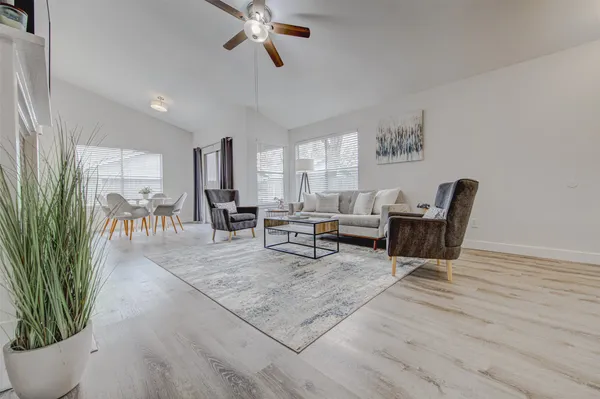 a living room with furniture and a potted plant
