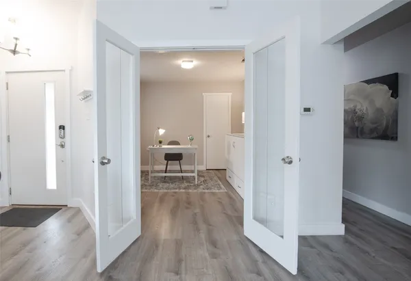 a view of a room with wooden floor lounge chair and windows