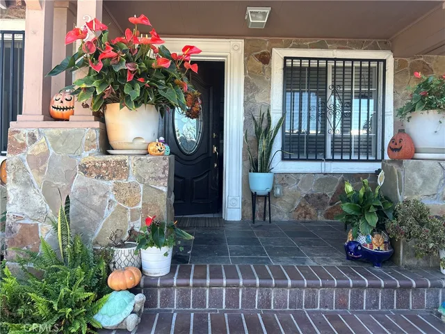 a front view of a house with flower pots