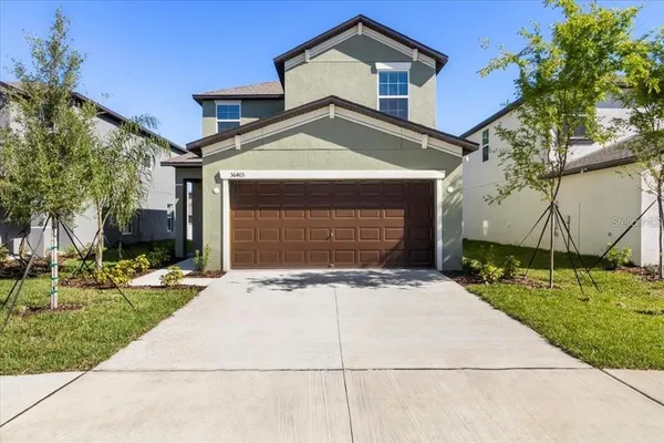 a front view of a house with a yard and garage