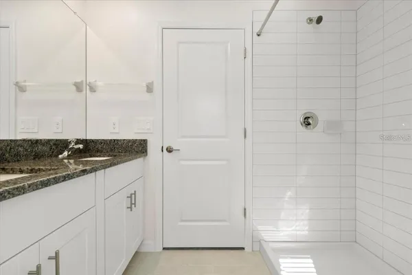 a bathroom with a shower and a sink